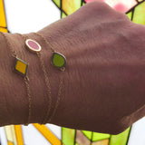 yellow, red and green enameled geometric charm stations on delicate 14k gold chain bracelet