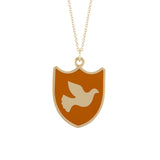 orange enameled shield shape pendant with silhouette of a peace dove in 14k gold