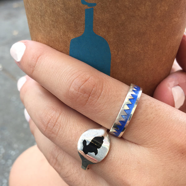 black silhouette bunny ring and blue zig zag ring